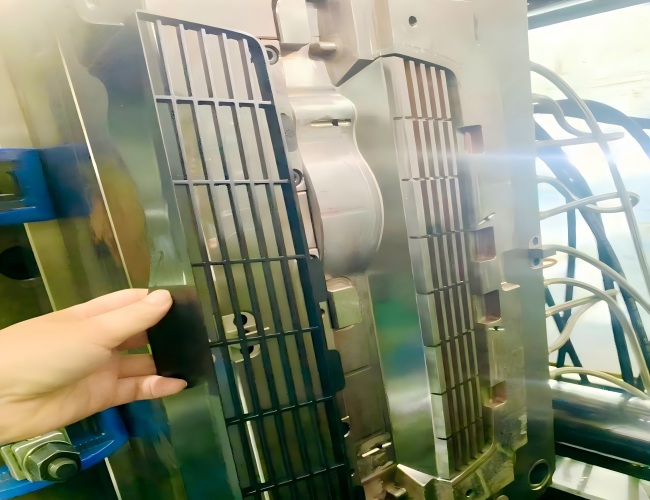 Engineer-led-founder-reviewing-a-complex-automotive-mold-trial-with-the-team