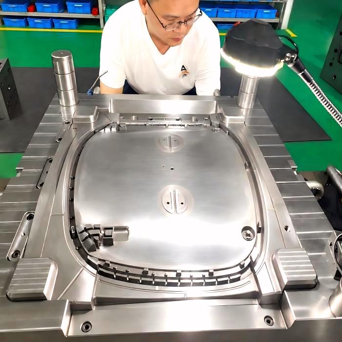KTM-engineer-founder-reviewing-injection-mold-tooling-on-the-factory-floor